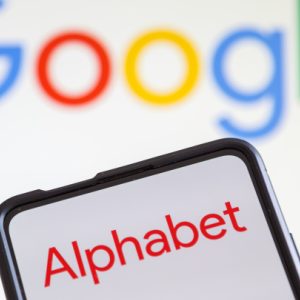 Google and Alphabet logo on a mobile phone and screen.