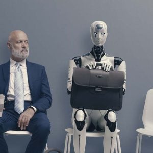 Business man sitting in waiting room next to robot with briefcase